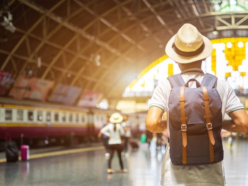 man-traveler-with-backpack-waiting-for-train-back-2023-11-27-04-58-42-utc